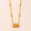 Gold plated braided rope necklace featuring a detailed cylindrical talisman charm pendant. - Pony