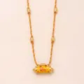Close-up details of the fashion lion prayer wheel braided necklace with gold beads. - Lion