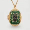 Detailed view of gold-plated oval locket necklace with green enamel Taurus and card design. - Taurus