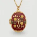Detailed close-up of gold-plated oval zodiac Scorpio locket necklace with exquisite enamel. - Scorpio