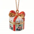 Close-up detail of Christmas gift box pendant necklace with enamel red bow and gold chain. - Blueberry Cylinder Style