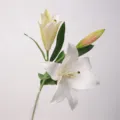 Artificial lily flower detail showing realistic moist touch petals and green leaves for home. - White