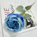Close-up detail of a blue artificial Austin rose flower decoration for home decor. - Blue