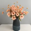 Artificial peach chrysanthemum flower bouquet in dark vase for home decor photography. - Deep Champagne