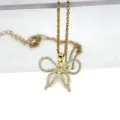 Variante dorée collier en acier titane avec pendentif nœud en zircone brillant - Style Papillon Doré