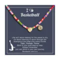 Colorful beaded necklace featuring gold heart and basketball pendants on a sports card. - Basketball Sports Beaded Style (2026-03-N-5576) / Multicolor
