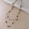 Detailed closeup of the retro Maillard style beaded necklace featuring pearls and tiger eye. - 19# Necklace-Gold-Brown