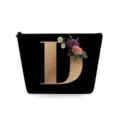 Detailed view of the black cosmetic pouch featuring a elegant golden letter D and floral print. - Capital Letter D Style