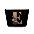 Zwarte cosmetische make-up tas met gouden letter E en vintage bloemmotief opdruk. - Hoofdletter E Stijl