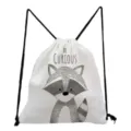 Close-up detail of the cute raccoon print and BE CURIOUS text on the white drawstring bag. - Raccoon Pattern (sk3060)