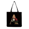 Close-up of black canvas tote bag featuring gold letter A and vintage floral print design. - Letter A Print (hm3192)