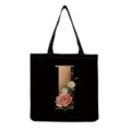 Detail view of black canvas tote bag featuring gold letter I and vintage floral print design. - Letter I Print (hm3392)
