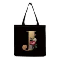 Black canvas tote bag detail featuring a gold floral monogram letter J design closeup. - Letter J Print (hm3199)