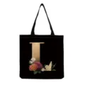 Detailed view of black canvas tote bag featuring a gold letter L and vintage floral print. - Letter L Print (hm3242)
