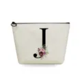 Close-up detail of the canvas cosmetic bag with black letter J and watercolor floral print. - Letter J Style