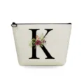 Canvas cosmetic bag detail, featuring black letter K print and watercolor floral pattern. - Letter K Style