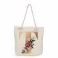 Detailed view of canvas tote bag with golden letter T and vintage floral print design. - Golden Letter T Print Style
