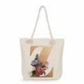 Detailed view of the stylish canvas tote bag featuring a metallic gold letter Z and floral print. - Golden Letter Z Print Style