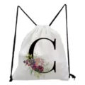 Minimalist white drawstring backpack featuring a stylish black letter C and floral print. - Letter C Style