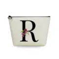 Detailed view of the stylish canvas cosmetic bag featuring a bold letter R and floral print. - Letter R Style