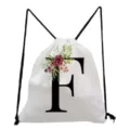 White canvas drawstring backpack featuring a stylish floral letter F print design for daily use. - Letter F
