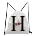 White canvas drawstring backpack featuring a stylish black letter H and floral print detail. - Letter H Style