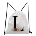 White drawstring backpack featuring a black letter L and watercolor floral print detail. - Letter L