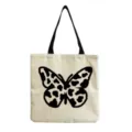 Close-up detail view of canvas tote bag featuring unique black cow print butterfly graphic design. - Cow Pattern Butterfly Print(hm3351)