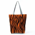 Detailed view showing the orange tiger stripe pattern and gray handle of canvas tote bag - Orange And Black Tiger Stripe (hl2695)