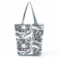 Close up detail of white canvas tote bag with abstract black tiger face graphic print pattern. - Abstract Tiger Face (hl2702)
