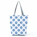 Large capacity canvas tote bag featuring classic blue evil eye pattern print with grey handles. - Blue Evil Eye (hl2703)