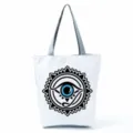 Close-up view of a casual canvas tote bag with a striking black and blue mystic eye print design. - Mystical Eye Pattern (hl2708)