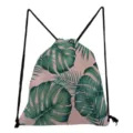 Tropical leaf print drawstring backpack with pink background and black cord. Detail view. - Pink Base Tropical Green Leaf Style (sk4792)