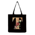 Detailed close-up of the black tote bag featuring a golden letter T and vintage floral. - Letter T Print (hm3259)
