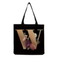 Detailed view of black canvas tote bag featuring gold letter W and vintage floral print. - Letter W Print (hm3258)