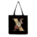 Black canvas tote bag featuring a chic gold letter X and vintage floral print for daily use. - Letter X Print (hm3395)
