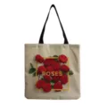 Detailed view of the linen tote bag featuring vibrant red roses and gold lettering print. - Light Linen Base Red Rose Gold Frame ROSES Style (hm0637)