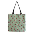 Detailed close-up view of canvas tote bag featuring pink rose floral print and black handles. - Light Green Base Retro Pink Rose Style (hm1055)