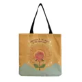 Close-up of artistic canvas tote bag featuring a retro rose and sunburst graphic print. - Vintage Rose Sun Print (hm3525)