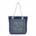 Blue canvas tote bag with white rope handles and elegant floral bandana pattern print. - Handheld Blue Base White Flower Style (ms3580)