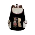 Detailed view of black canvas backpack featuring elegant floral letter R print and brown straps. - Black Letter R Style