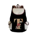 Detailed view of canvas backpack with floral letter T print, showing textured fabric quality. - Black Letter T Style