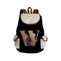 Detailed view of the black canvas backpack featuring a golden letter W with floral print and flap. - Black Letter W Style