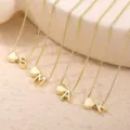 Collana in rame dorato con ciondolo a cuore e iniziale alfabetica dal design raffinato. - Collana con Lettera a Cuore (A-Z)
