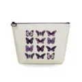 Close-up detail of the canvas makeup pouch featuring a stylish purple butterfly pattern print. - Purple Butterfly