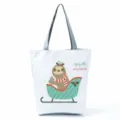 Cute sloth print canvas tote bag detail, Christmas holiday design with gray handles. - Christmas Sleigh Sloth Style (hl0915)