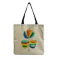 Dettaglio della borsa shopper in tela con stampa floreale astratta e manici neri resistenti. - Stile hm1225