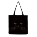 Black canvas tote bag detail featuring a realistic dark cat face print with glowing eyes. - Realistic Black Cat Face Style (hm3070)