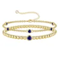 Bracciale multistrato dorato con ciondoli di pietre natali blu e delicate perline metalliche. - Dicembre