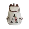 Detail view of canvas backpack with elegant letter A watercolor floral print and brown trim. - Letter A Print Style (sj2458)